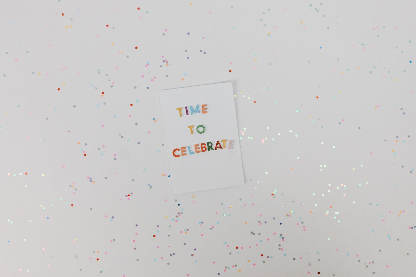 Colorful celebration card with confetti on a white background. Perfect for festive occasions.